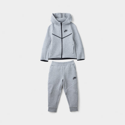 Nike Sportswear Children's Tech Fleece Full Zip Hoodie Set. Front view of dark grey heather hoodie and jogger set with black trim and Nike branding.