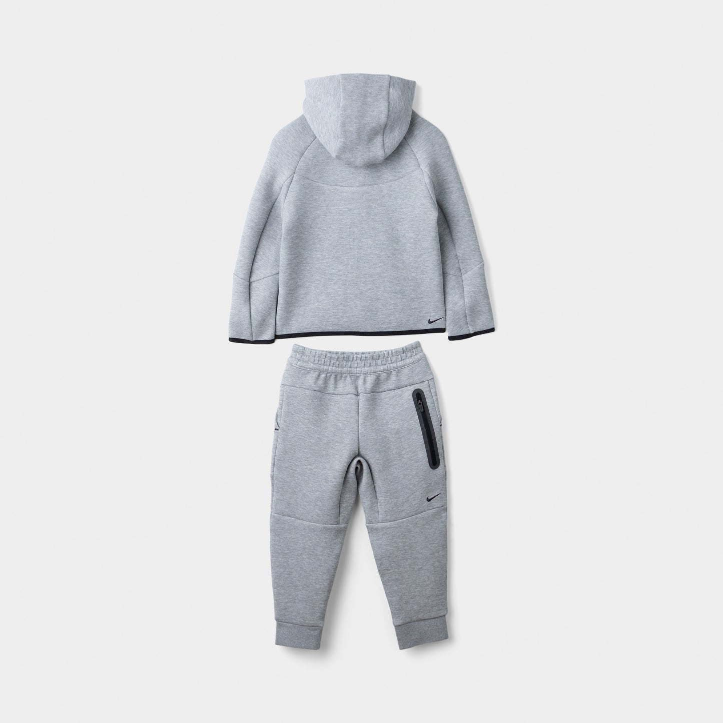 Nike Sportswear Children's Tech Fleece Full Zip Hoodie Set. Full view of dark grey heather hoodie and joggers with matching black Nike logos.