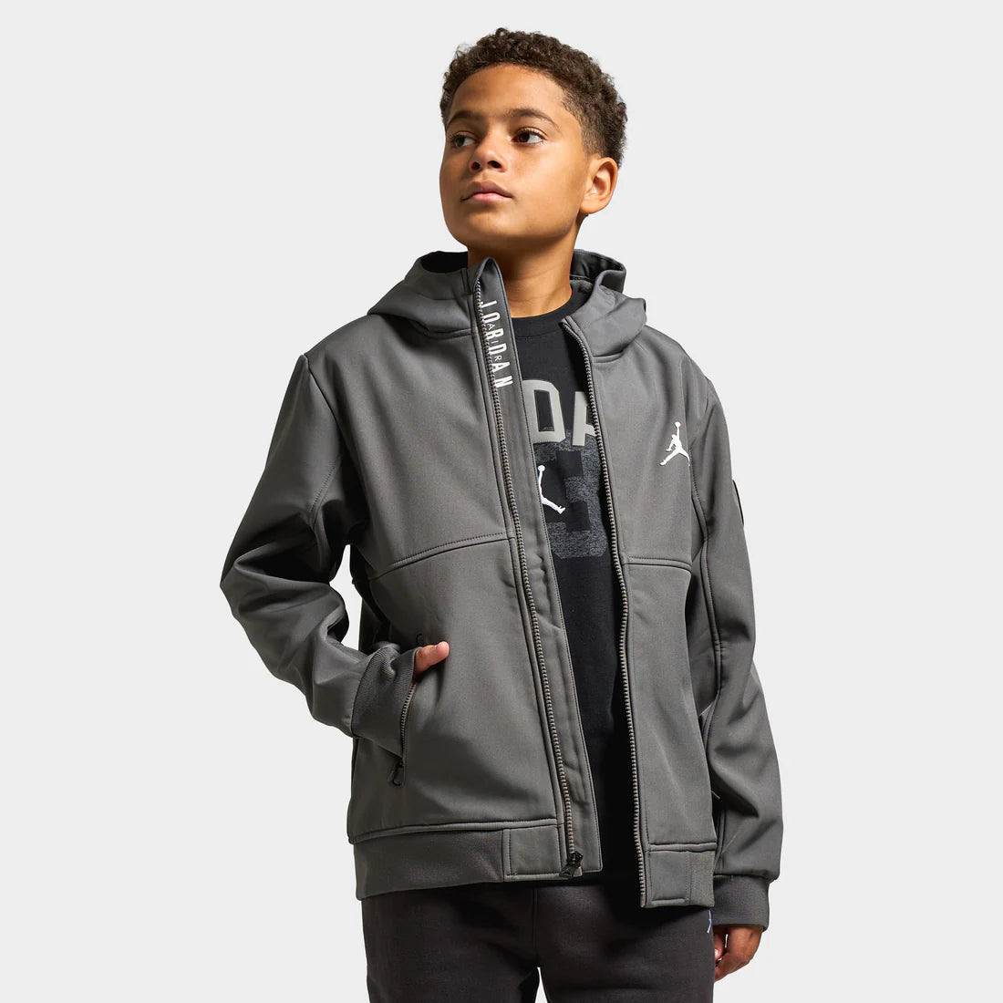 Kid wears Jordan Juniors Soft Shell Jacket “Iron Grey” jacket. Shop Kids’ Clothing now at JD Sports.