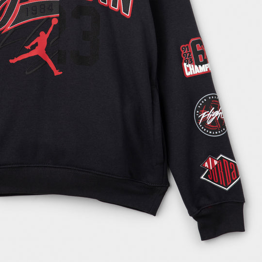 Jordan Juniors' Varsity Split Pullover Hoodie. Close-up of off noir hoodie showing embroidered-style patches along the sleeve.