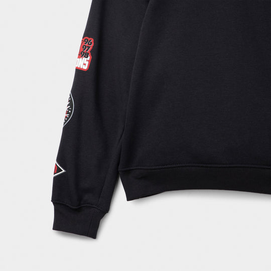 Jordan Juniors' Varsity Split Pullover Hoodie. Close-up of off noir sleeve showing ribbed cuff and small red patch detail.