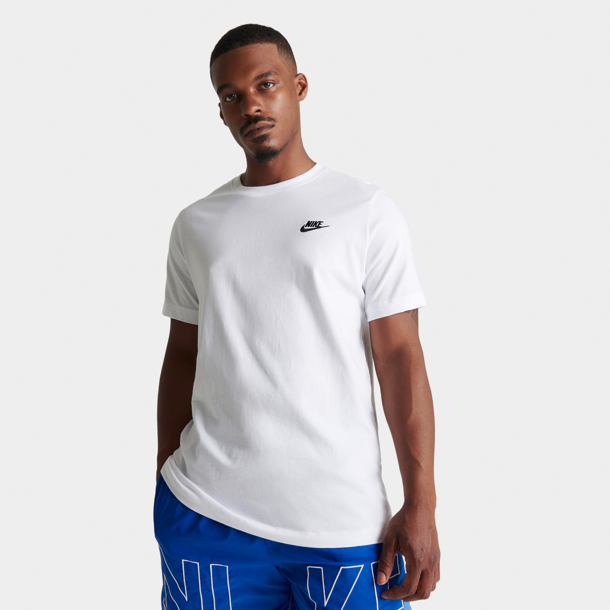 white nike shirt with blue logo