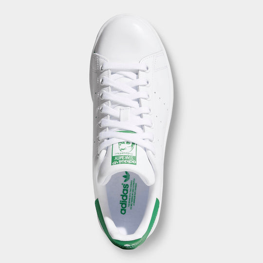 adidas Women's Stan Smith. Top view of white and green sneaker showing white laces, green tongue label and green heel detail.