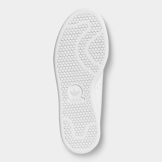 adidas Women's Stan Smith. Bottom view of white and green sneaker showing white outsole with textured tread pattern.