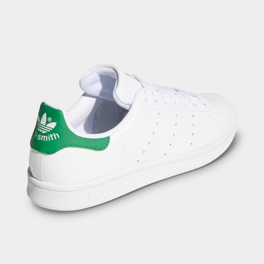 adidas Women's Stan Smith. Rear three-quarter view of white and green sneaker with green heel tab, padded collar and white midsole.
