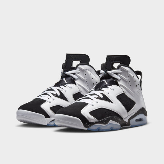 Jordan 6 Retro GS. Angled view of the pair in white, chrome and black showing the high-top shape, lace cover and visible Air unit.