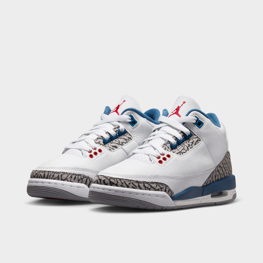 Jordan 3 Retro GS. Three-quarter view of White, Varsity Red, and True Blue sneaker with visible Air unit.