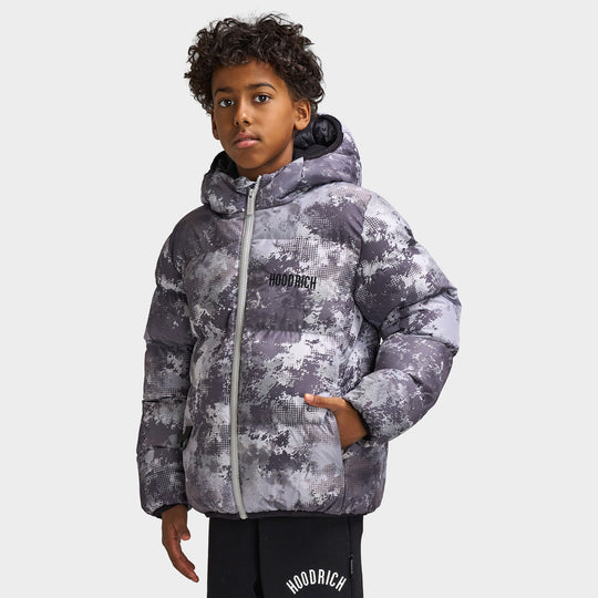 Hoodrich Juniors' Ark Puffer Jacket. Front view displaying grey and black digital camo print, padded baffle construction, insulated hood, and side entry pockets.