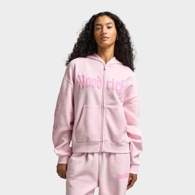 La femme porte le chandail zippé mi-long Hoodrich Totem pour femmes « Rose ». Magasinez les vêtements pour femmes dès maintenant