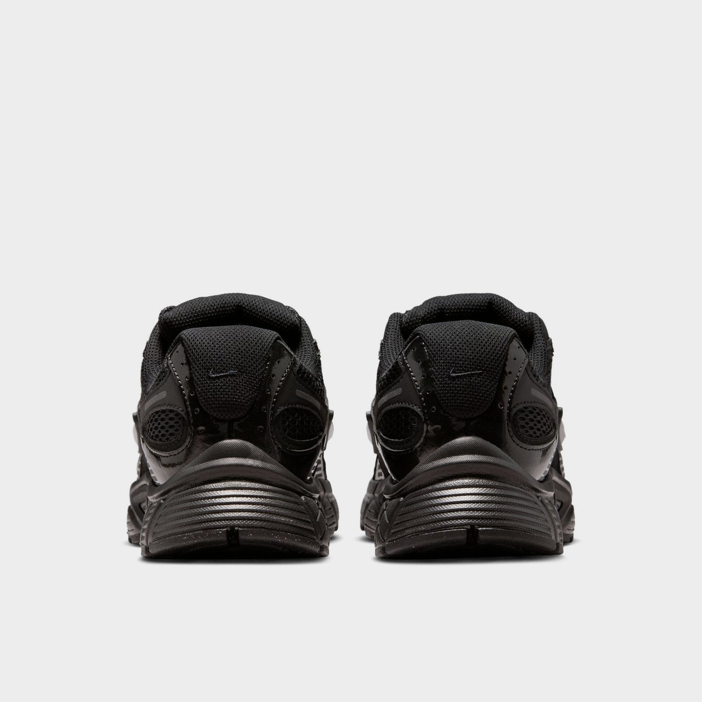 Nike Women's V5 RNR. Rear view of black and anthracite sneakers with layered heel panels and sculpted soles.