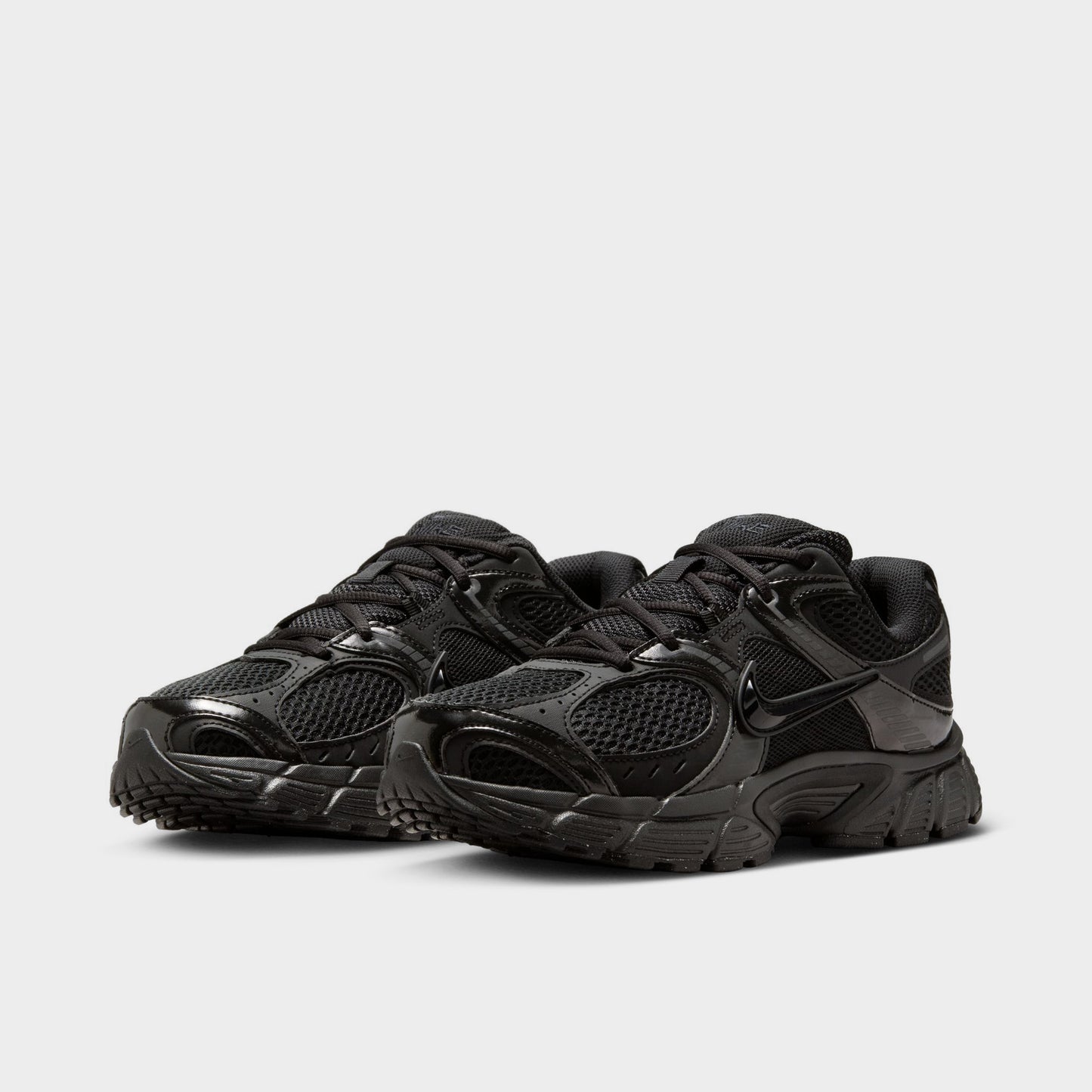 Nike Women's V5 RNR. Three-quarter view of black and anthracite sneakers with black laces, layered overlays and tonal branding.