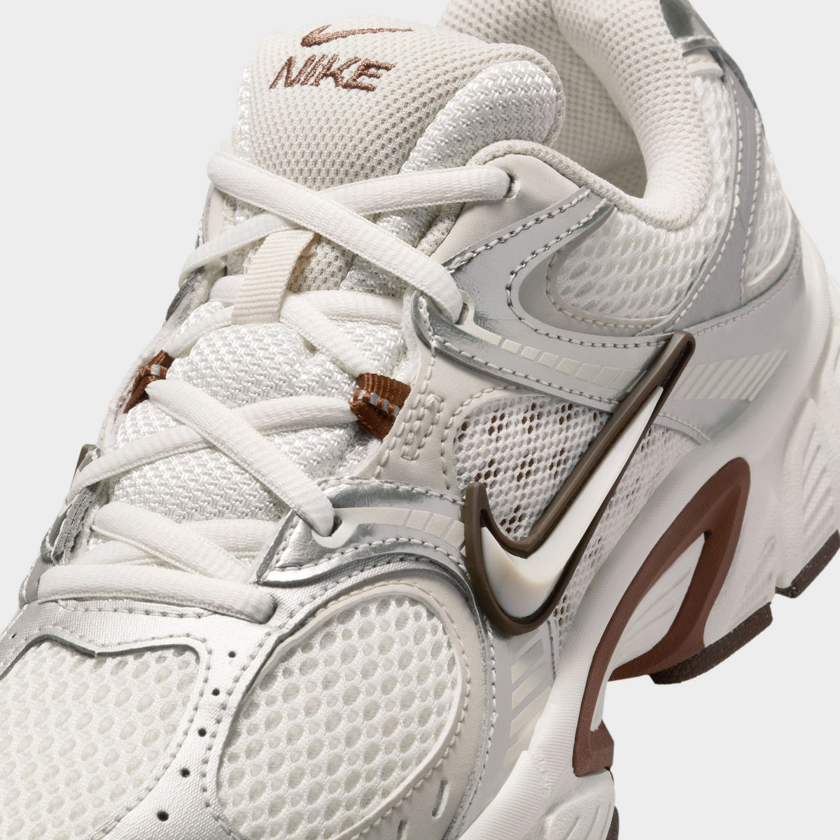 Nike Women's V5 RNR Salt / Light Orewood Brown - Fauna Brown close-up, cream sneakers showing white laces, mesh toe box and Nike Swoosh.