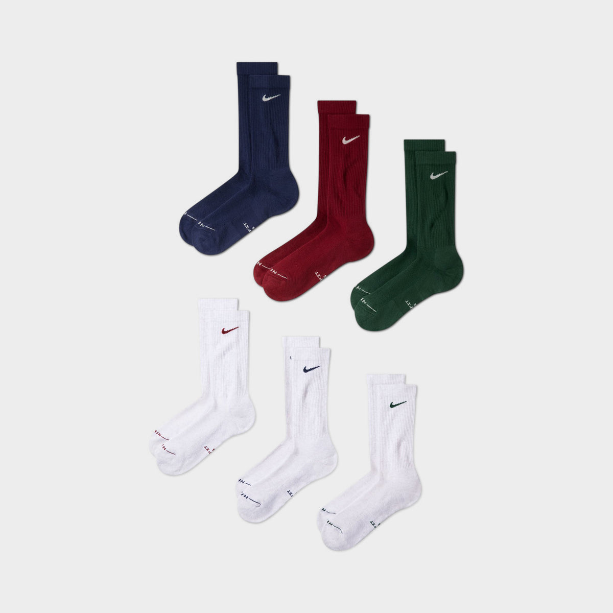 Nike Everyday Elevated Crew Socks (6-Pack). Front view of multicolour crew socks in navy, red, green and white with Nike Swoosh logos.