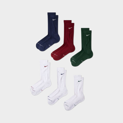 Nike Everyday Elevated Crew Socks (6-Pack). Front view of multicolour crew socks in navy, red, green and white with Nike Swoosh logos.