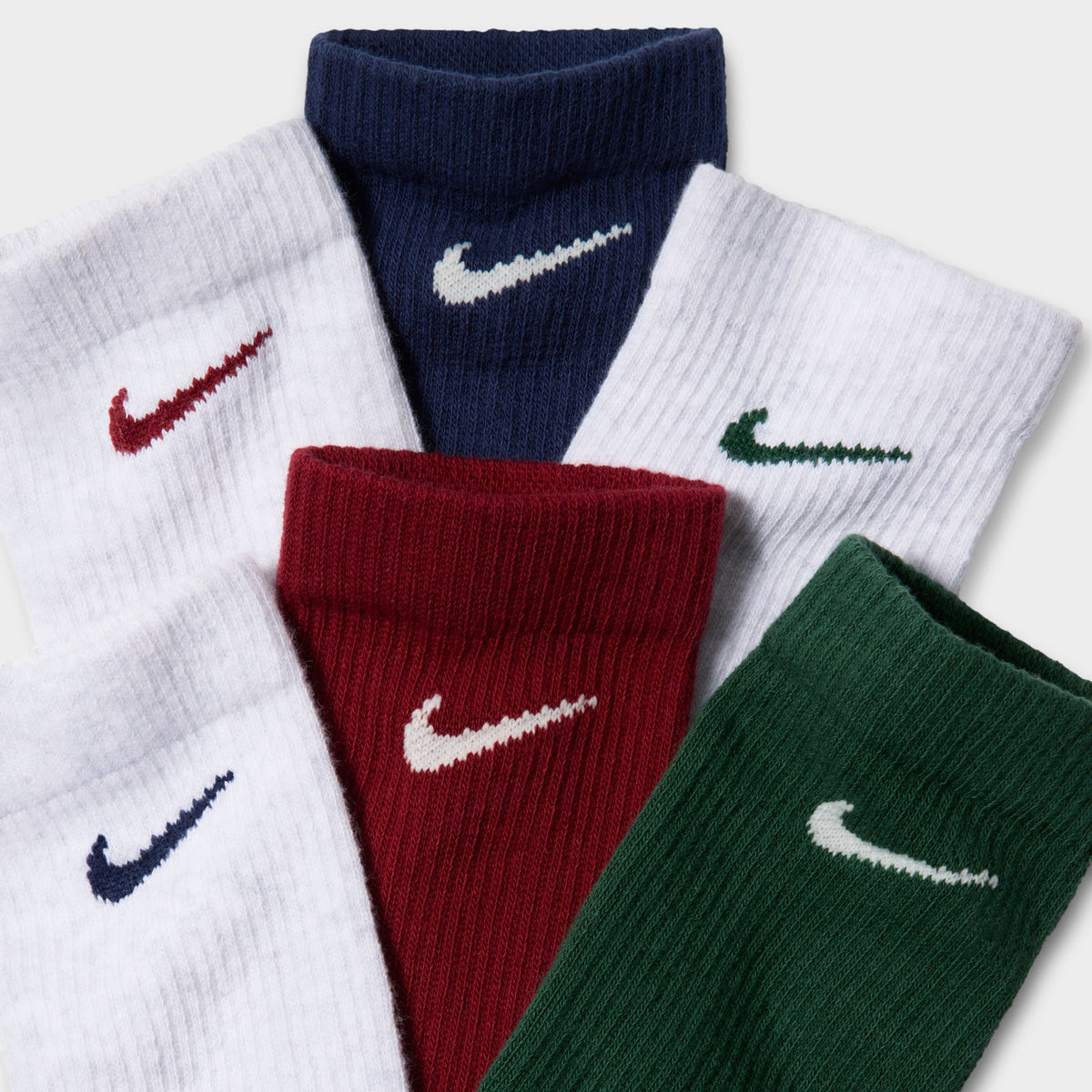 Nike Everyday Elevated Crew Socks (6-Pack). Close-up of multicolour crew socks showing ribbed cuffs and embroidered Nike Swoosh logos.