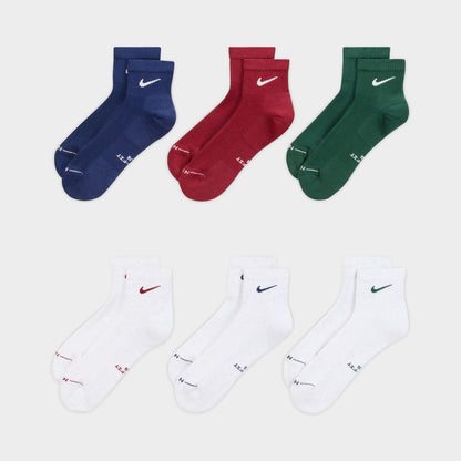 Nike Everyday Elevated Ankle Socks (6-Pack). Front view of multicolour ankle socks in navy, red, green and white with Nike Swoosh logos.
