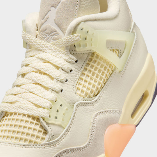 Jordan Women’s 4 Retro. Close-up of Coconut Milk, Muslin, and Bright Mango sneakers with an Encapsulated Air-Sole unit.