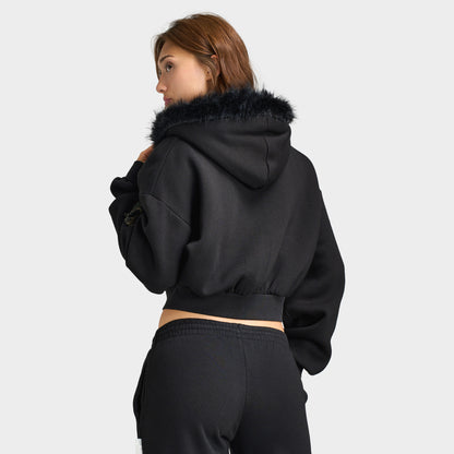 Hoodrich Women's Camo Rift Boxy Zip-Through Hoodie. Upper body rear view displaying the black boxy cropped hoodie with plush black faux-fur trimmed hood edge, dropped shoulders, and ribbed waist hemline. 