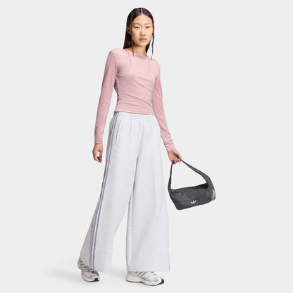 adidas Spacer Track Pants. Full-body view of model wearing light grey heather and silver track pants with a pink top and white sneakers.