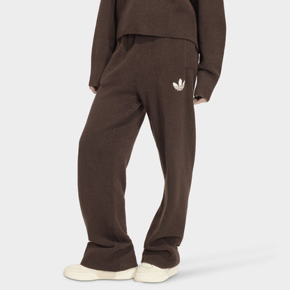 adidas Essentials Knit Pant. Front view of model wearing aurora coffee pants with wide legs, elastic waistband and white Trefoil logo.