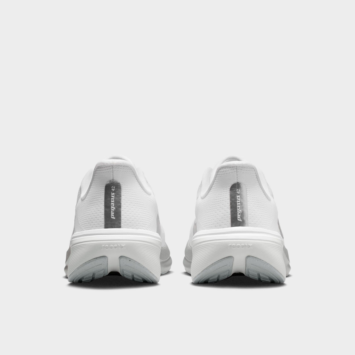 Nike Women's Pegasus 42. Rear view of white, metallic silver and wolf grey running shoes with padded heel panels and sculpted soles.