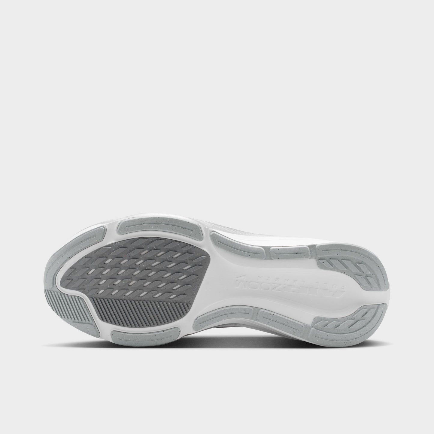 Nike Women's Pegasus 42. Bottom view of white, metallic silver and wolf grey running shoe showing grey rubber sections and segmented tread.