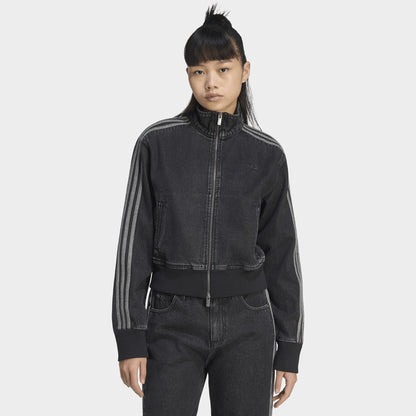 adidas Firebird Denim Track Top. Front view of model wearing true black denim track jacket with full-zip closure, high collar and tonal three stripes.