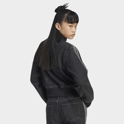 adidas Firebird Denim Track Top. Back three-quarter view of model wearing true black denim track jacket with plain back, high collar and relaxed sleeves.