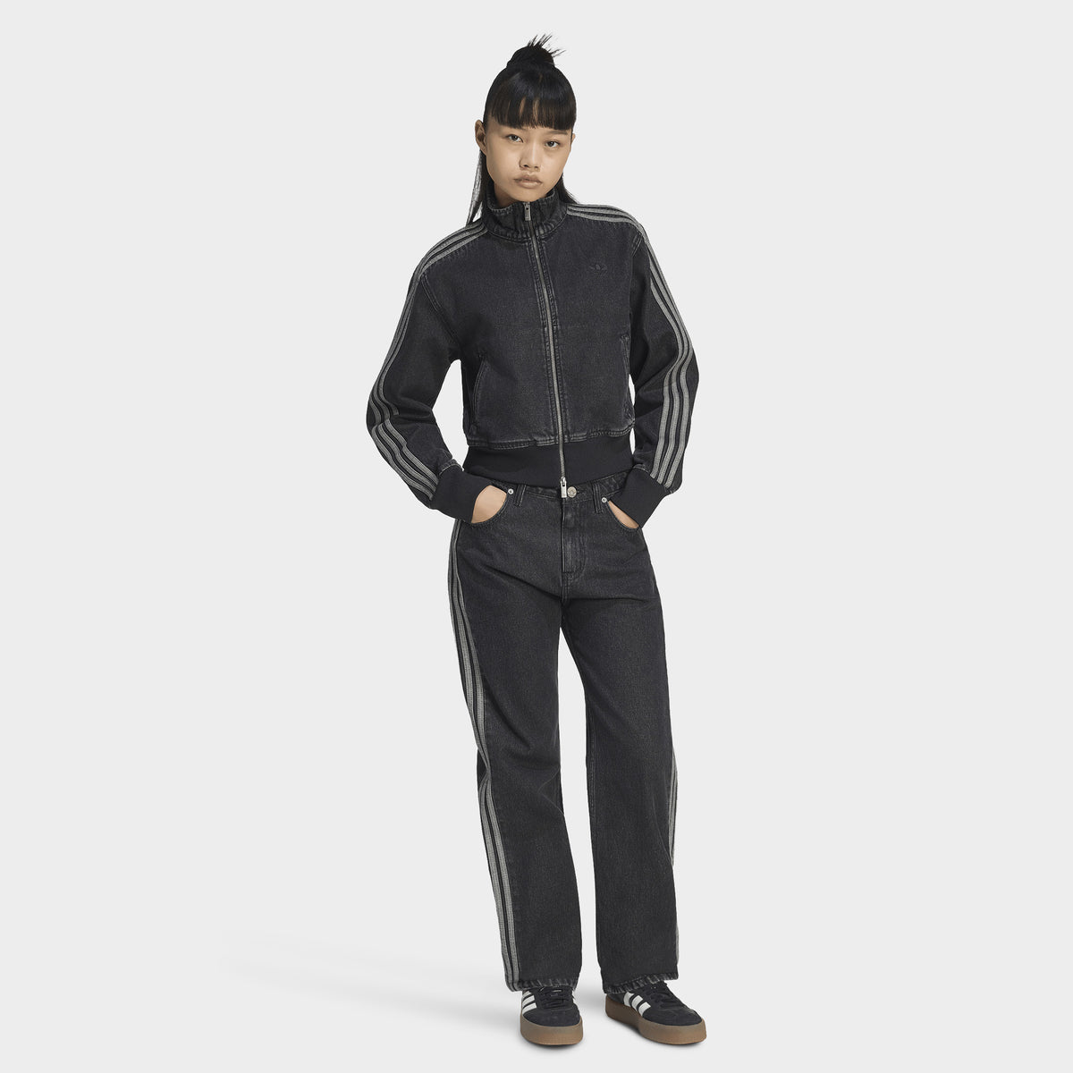 adidas Firebird Denim Track Top. Full-body view of model wearing true black denim track jacket with matching pants and black shoes.