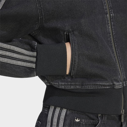 adidas Firebird Denim Track Top. Close-up of true black denim track jacket showing zippered side pocket, contrast stitching and striped sleeve.