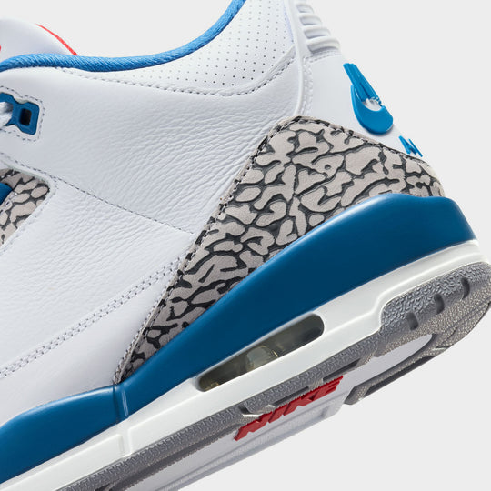 Jordan 3 Retro. Close-up view of White, True Blue, and Fire Red sneaker with visible Air unit.