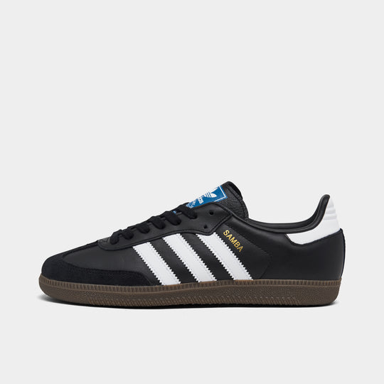 adidas Originals Women's Samba OG. Side view of core black, white and clear granite sneaker with white three stripes, black suede toe overlay and dark gum sole.