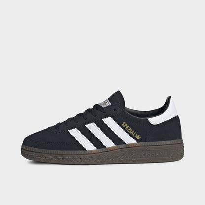adidas Juniors' Handball Spezial. Side view of black, white and gum junior sneaker with white three stripes, gold Spezial branding and gum sole.