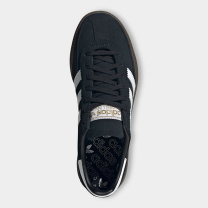 adidas Juniors' Handball Spezial. Top view of black, white and gum junior sneaker showing black laces, padded tongue and dark insole.
