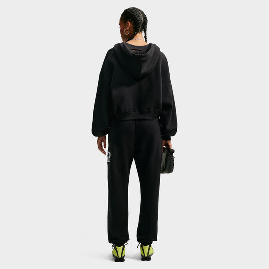 Nike Studio Fleece Cropped Full Zip Hoodie. Full-body back view of model wearing black cropped hoodie with matching black pants.