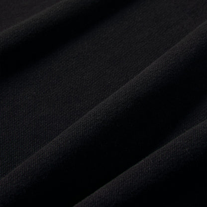 Nike Studio Fleece Cropped Full Zip Hoodie. Close-up of black fleece fabric showing the smooth brushed texture.