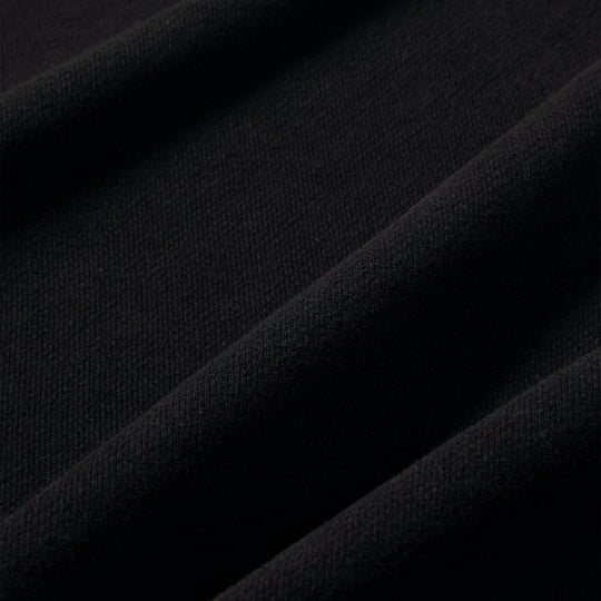 Nike Studio Fleece Cropped Full Zip Hoodie. Close-up of black fleece fabric showing the smooth brushed texture.