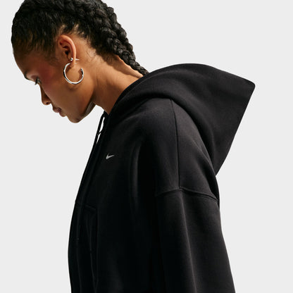Nike Studio Fleece Cropped Full Zip Hoodie. Side close-up of black cropped hoodie showing the raised hood, relaxed shoulder and soft fleece construction.