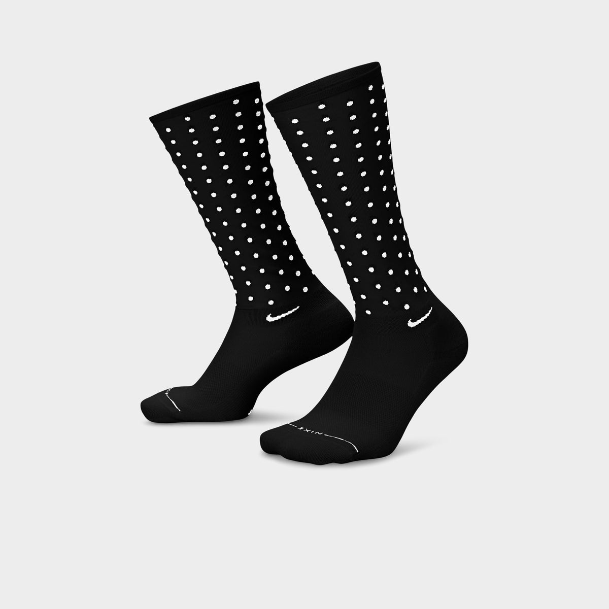 Nike Elevated Sheer Socks (1-Pair). Three-quarter view of football grey sheer crew socks with dotted panels, ribbed cuffs and solid feet.