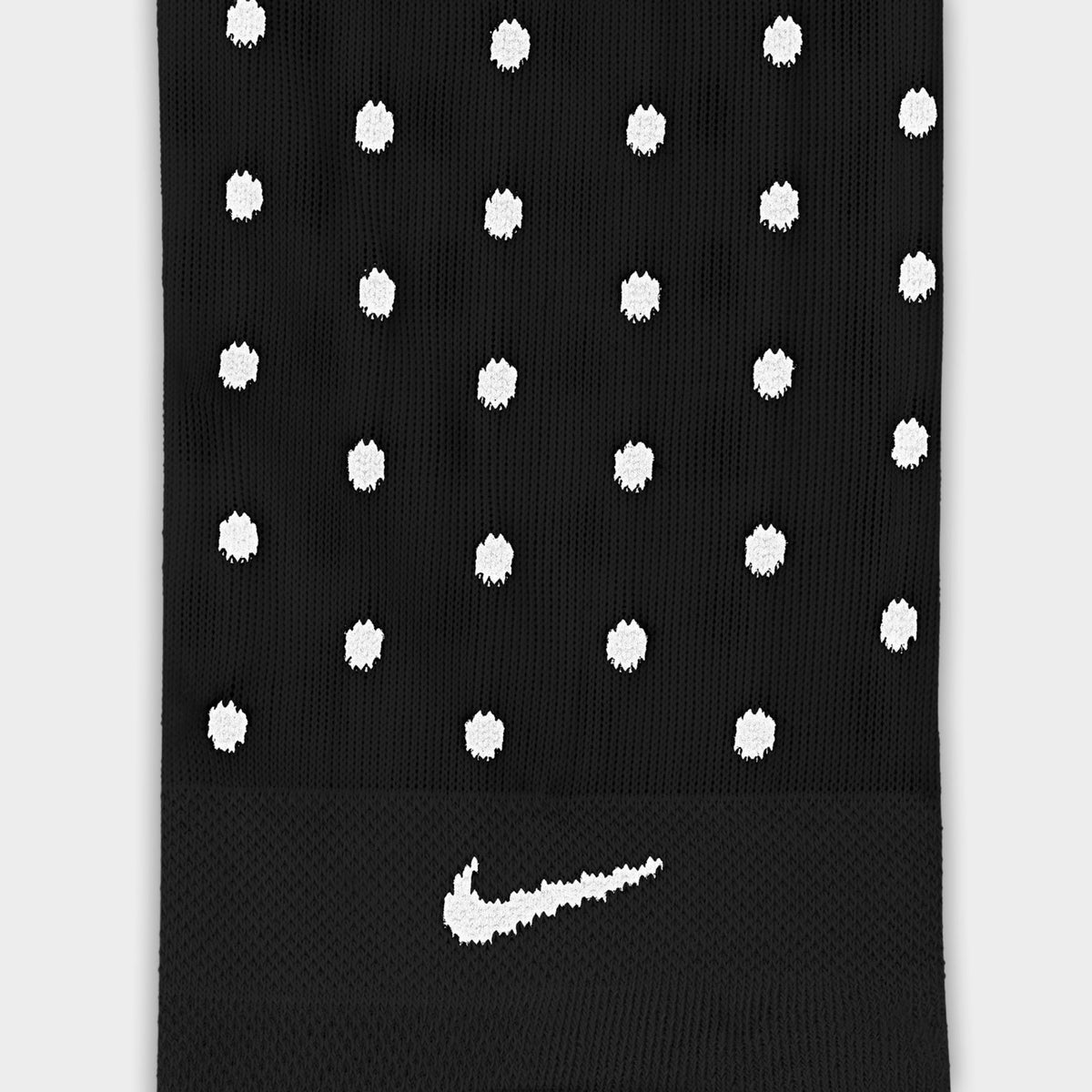 Nike Elevated Sheer Socks (1-Pair). Close-up of football grey sheer sock showing white dotted pattern and white Nike Swoosh logo.