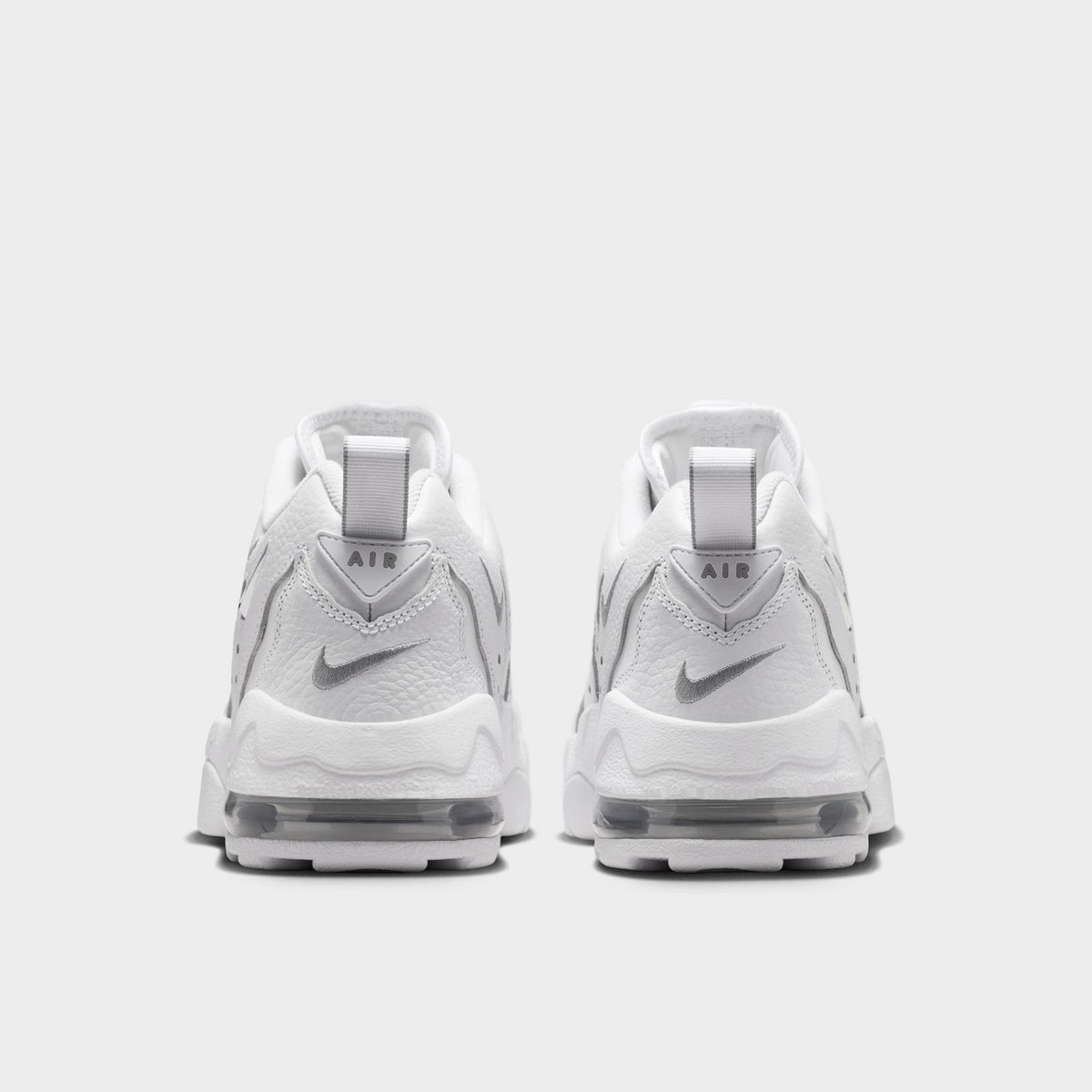 Nike Air DT Max '96 Low. Rear view of white and metallic silver sneakers with padded heel panels and layered soles.
