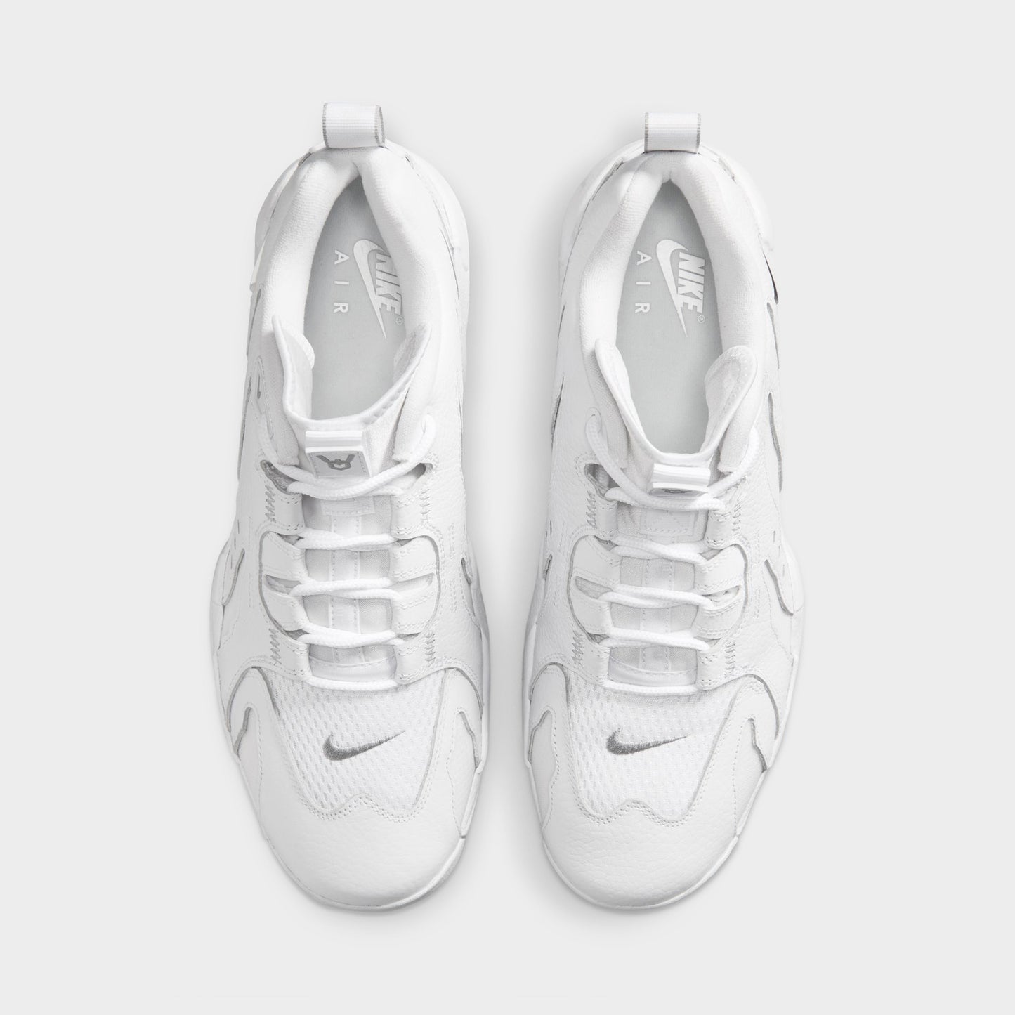 Nike Air DT Max '96 Low. Top view of white and metallic silver sneakers showing white laces, padded tongues and perforated uppers.