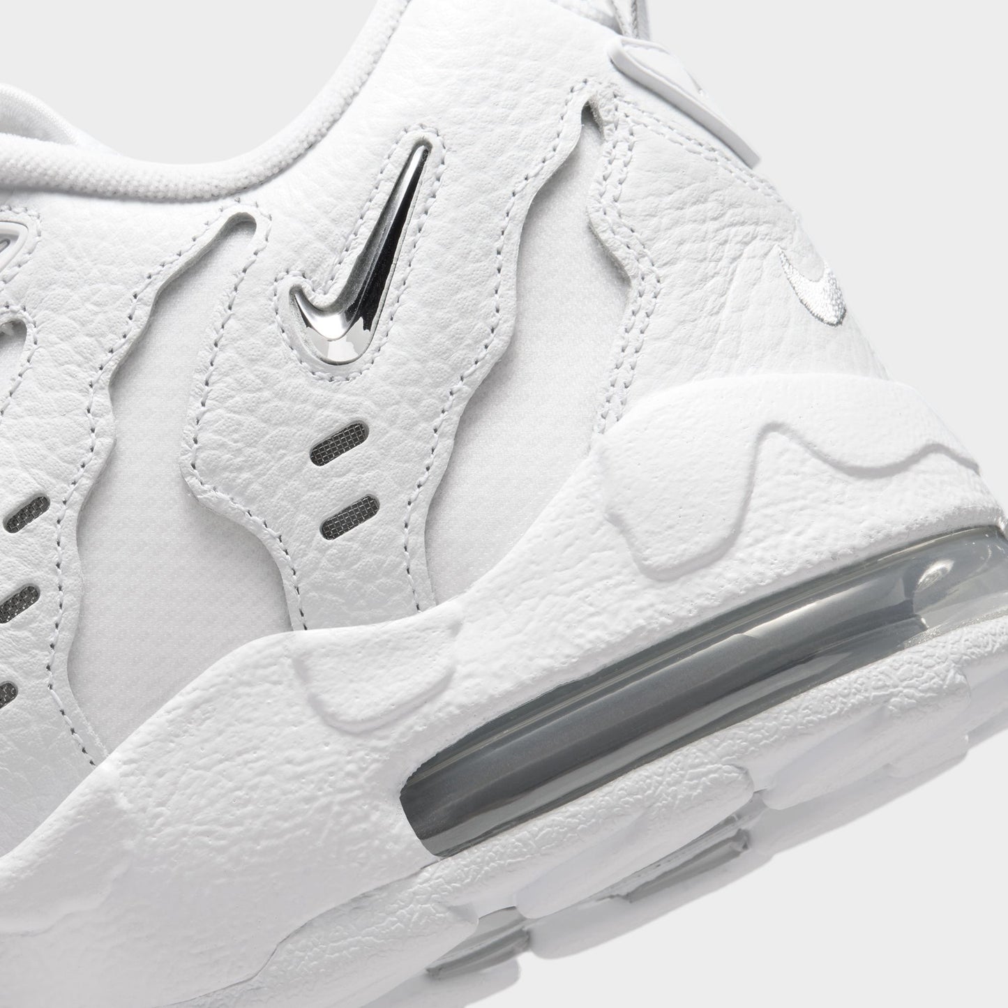 Nike Air DT Max '96 Low. Close-up of white and metallic silver sneaker showing sculpted heel panels and visible Air cushioning.