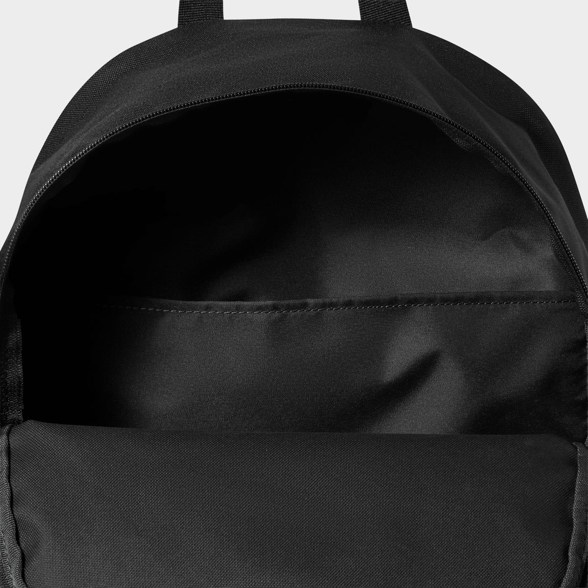 Nike AF1 Heritage Backpack. Interior view of black backpack showing the open main compartment and internal sleeve.