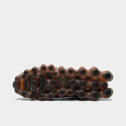 Nike Air Liquid Max. Bottom view of black, metallic silver and light army sneaker showing dark outsole with visible amber Air pod structure.
