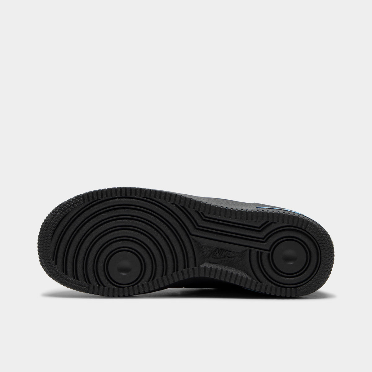 Nike Air Force 1 GS. Bottom view of single shoe displaying full anthracite rubber outsole with classic Air Force 1 concentric circle tread pattern. 