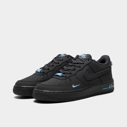 Nike Air Force 1 GS. Three-quarter view of pair of low-top sneakers showing anthracite leather uppers, tonal laces, football blue accents, and anthracite midsoles. 