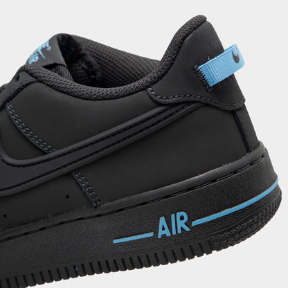 Nike Air Force 1 GS. Close-up view of lateral heel highlighting anthracite leather overlays, football blue heel pull tab, stitched midsole, and blue AIR branding. 