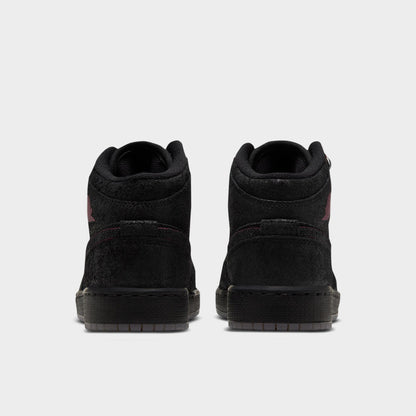 Jordan 1 Mid SE GS. Rear view displaying black textured leather heel overlays, padded ankle collar, and solid black midsoles. 