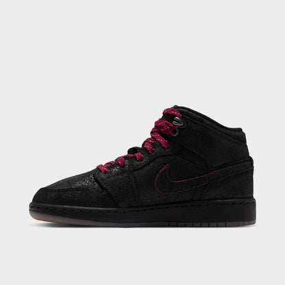 Jordan 1 Mid SE GS. Lateral side view featuring black textured upper, team red outlines around Swoosh, black midsole, and gum medium brown outsole. 
